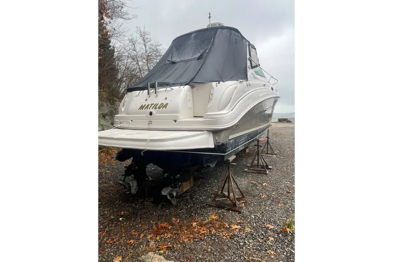 Slide: The Image of 2006 Sea Ray Sundancer 280 boat on stands, covered, with "Matilda" on the stern. - 19