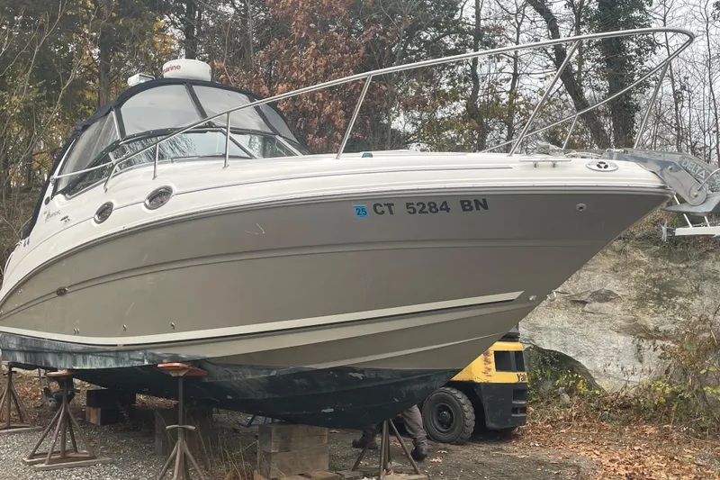 Slide: The Image of 2006 Sea Ray Sundancer 280 boat on stands, surrounded by trees. - 8