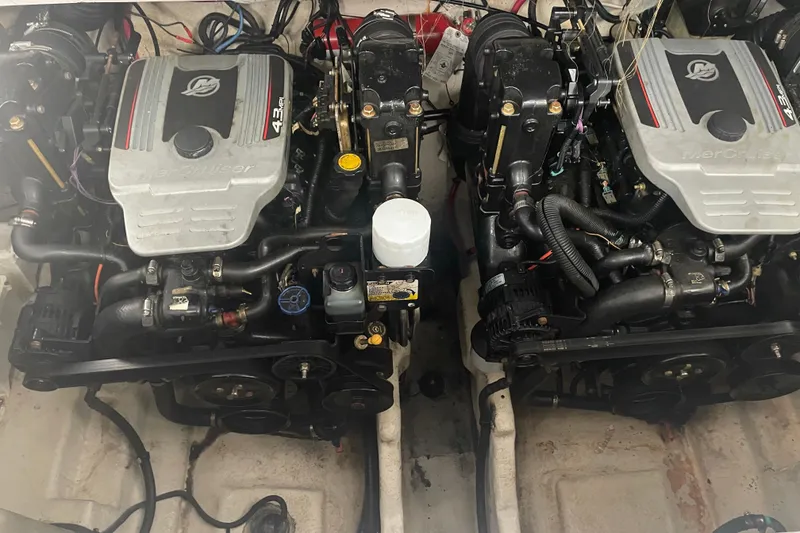 Slide: The Image of Twin engines of a 2006 Sea Ray Sundancer 280 boat, showcasing mechanical components. - 9