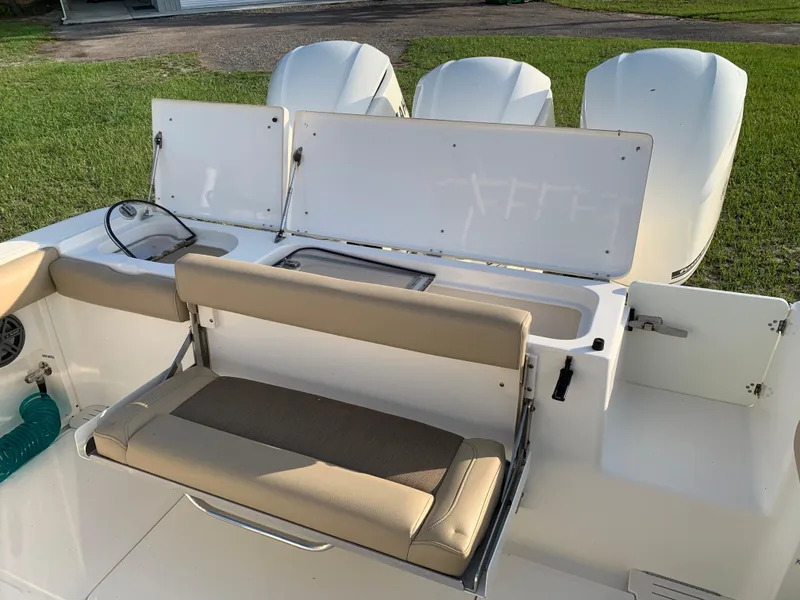 Slide: The Image of 2016 Key West 351 Billistic boat with triple outboard engines and beige seating. - 11