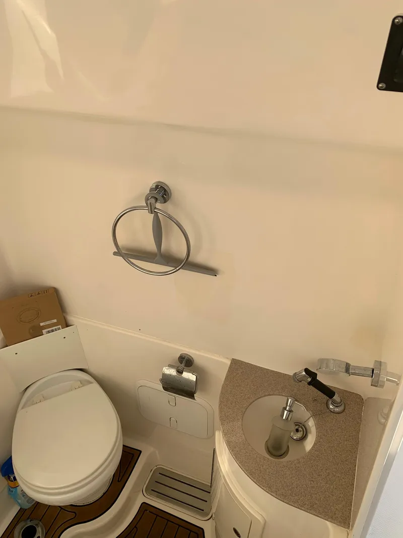 Slide: The Image of 2016 Key West 351 Billistic boat bathroom with toilet, sink, and towel ring. - 30