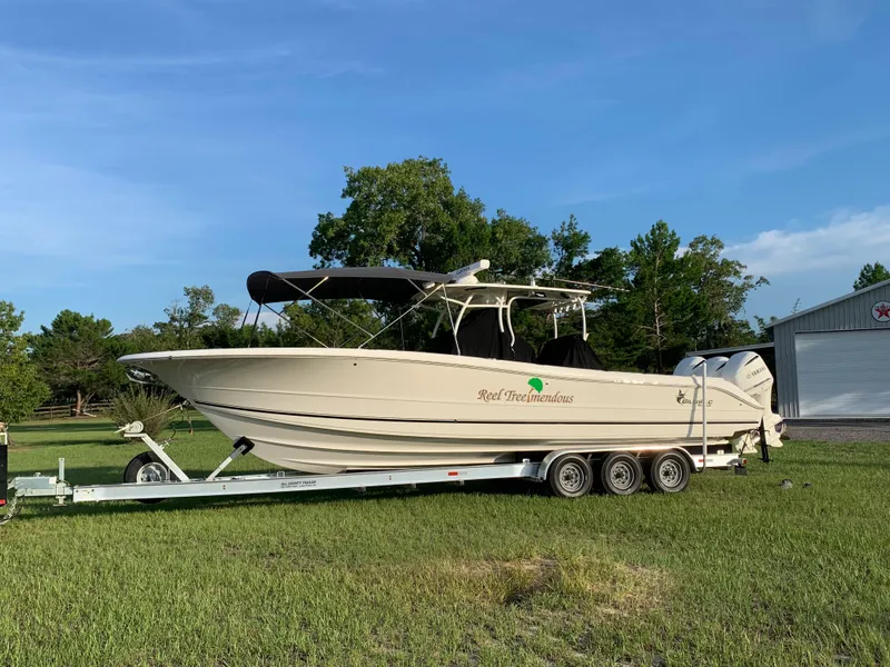 Slide: The Image of 2016 Key West 351 Billistic boat on a trailer in a grassy area. - 4