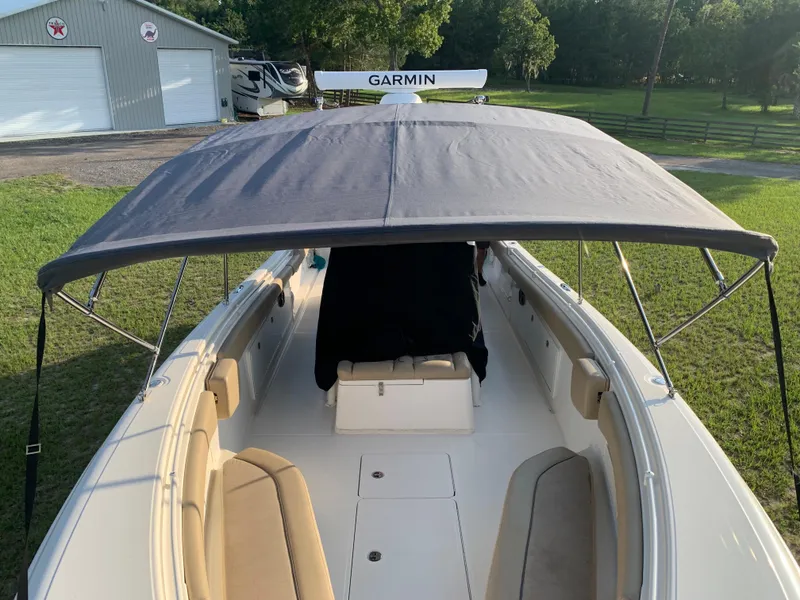 Slide: The Image of 2016 Key West 351 Billistic boat with canopy and Garmin equipment, parked outdoors. - 49