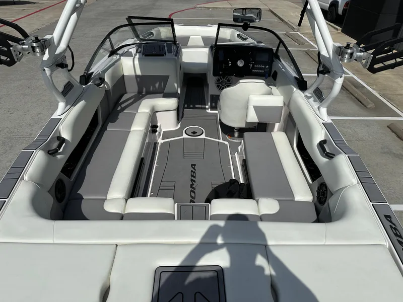 Slide: The Image of 2024 Moomba Max boat interior with white and gray seating, modern dashboard, and spacious layout. - 12