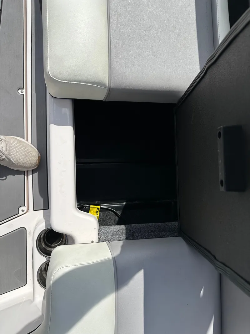 Slide: The Image of 2024 Moomba Max boat interior with open storage compartment and seating. - 16