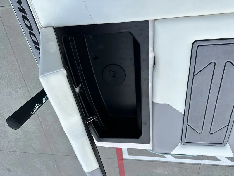 Slide: The Image of 2024 Moomba Max boat storage compartment with open lid, showcasing interior design. - 23