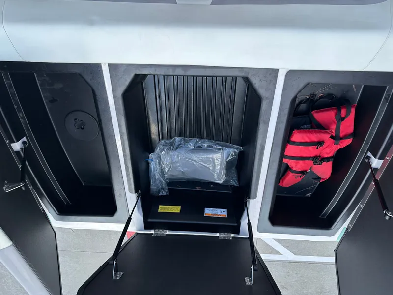 Slide: The Image of 2024 Moomba Max boat storage compartments with life jackets and equipment. - 24