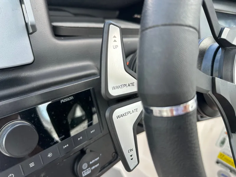 Slide: The Image of 2024 Moomba Max wakeplate controls and Fusion audio system on dashboard. - 29