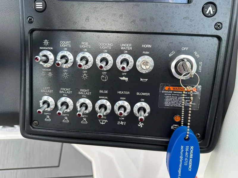 Slide: The Image of Control panel of a 2024 Moomba Max boat with various switches and ignition key. - 31