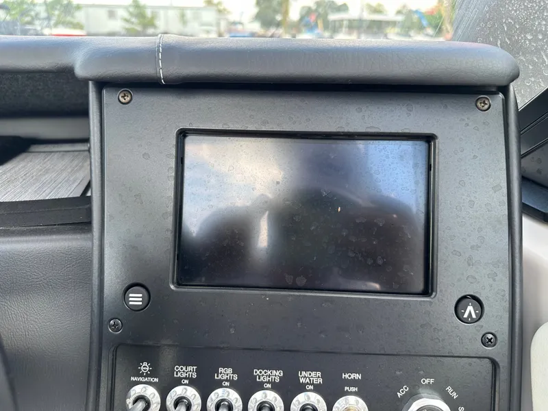 Slide: The Image of 2024 Moomba Max boat dashboard with touchscreen and control switches. - 32