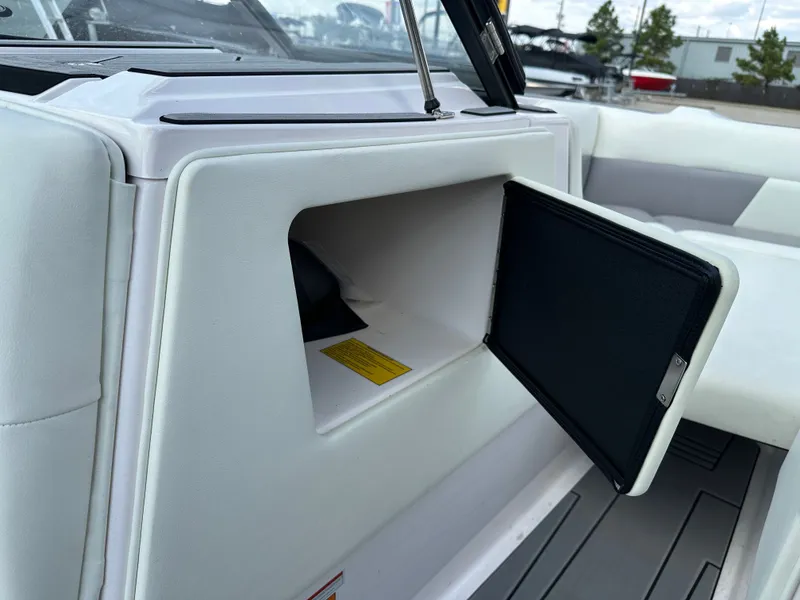 Slide: The Image of 2024 Moomba Max boat storage compartment with open hatch, showcasing interior space. - 35