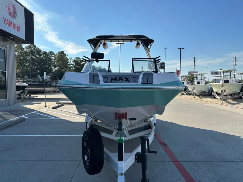 Slide: The Image of 2024 Moomba Max boat on trailer at dealership, sunny day. - 5