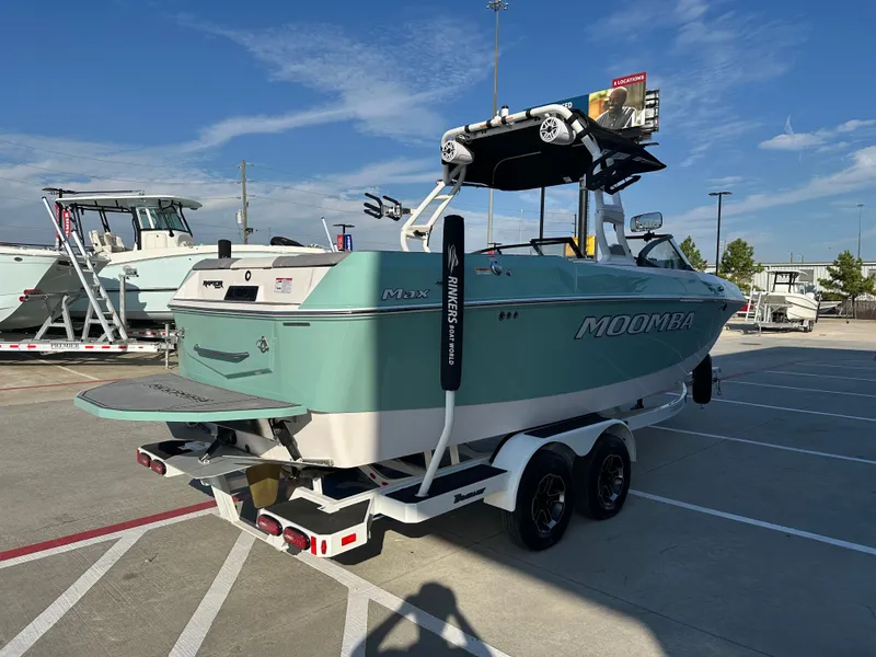 Slide: The Image of 2024 Moomba Max boat on trailer in outdoor dealership lot. - 8