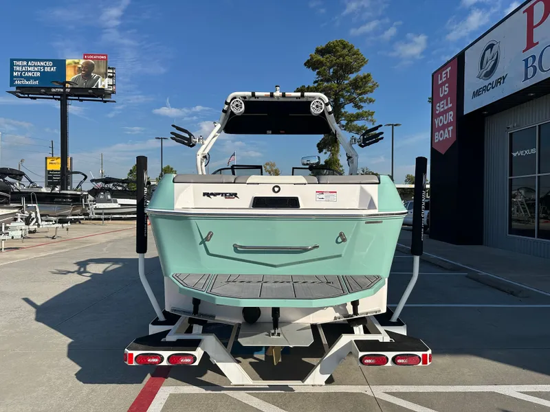 Slide: The Image of 2024 Moomba Max boat in a dealership lot under a clear blue sky. - 9