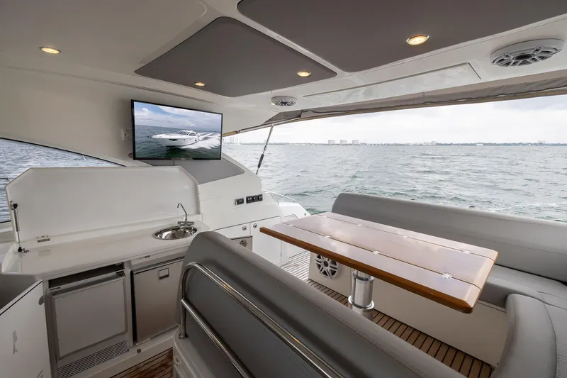 Slide: The Image of Interior of 2014 Beneteau Gran Turismo 44 yacht with seating, table, and kitchenette. - 11