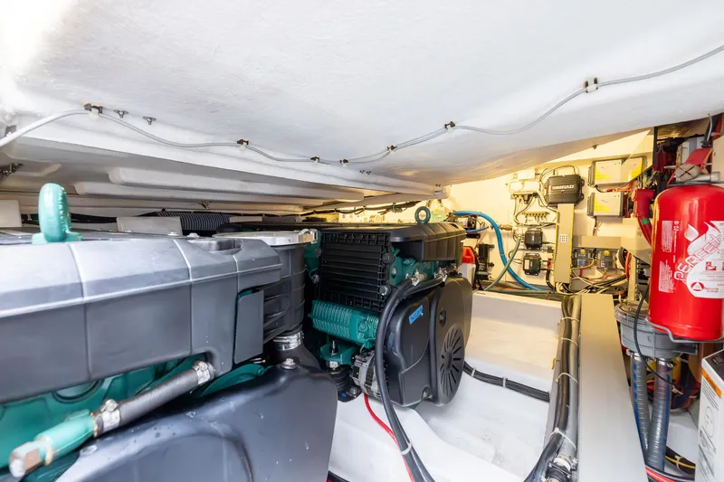 Slide: The Image of Engine room of 2014 Beneteau Gran Turismo 44 with visible machinery and fire extinguisher. - 28