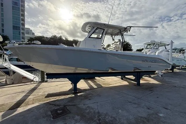 The Image of 2025 Solace 28HCS boat on display at marina under cloudy sky. - 0