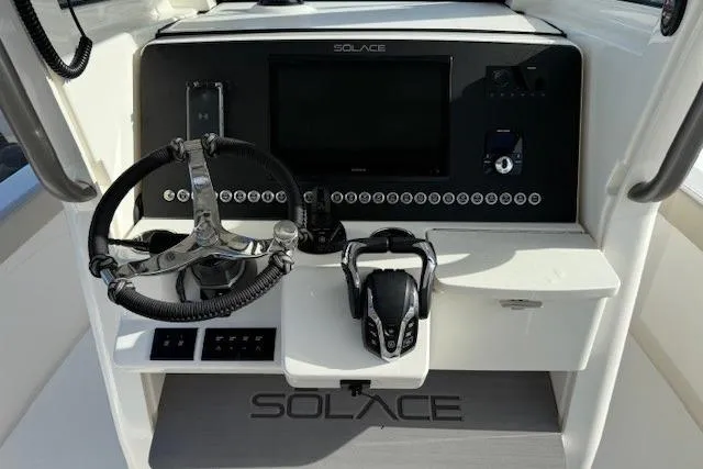 Slide: The Image of 2025 Solace 28HCS boat dashboard with steering wheel and control panel. - 3