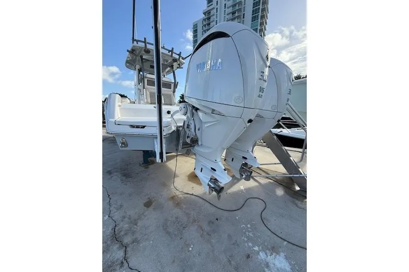 Slide: The Image of 2025 Solace 28HCS boat with dual Yamaha outboard engines, docked under a clear sky. - 5