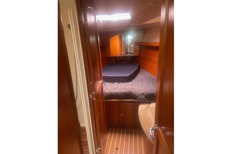 Slide: The Image of 2007 Marlow-Hunter 45CC yacht cabin with wooden interior and cozy bed. - 3