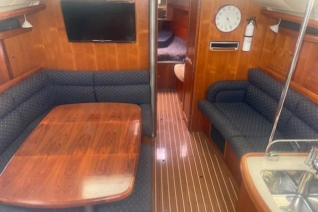 Slide: The Image of Interior of 2007 Marlow-Hunter 45CC yacht with wood finish and seating area. - 4