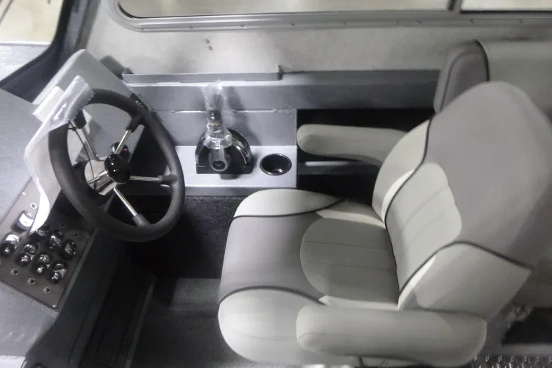 Slide: The Image of Interior of 2026 KingFisher 2425 Escape HT boat with steering wheel and captain's chair. - 18