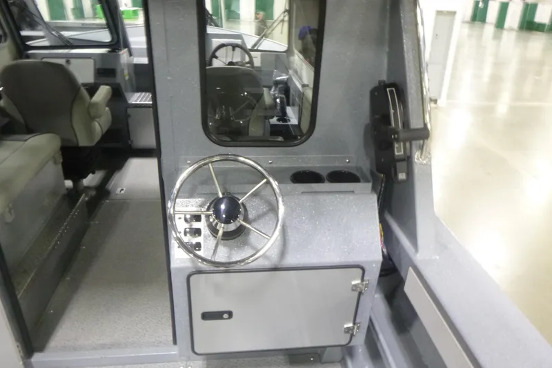 Slide: The Image of Interior view of 2026 KingFisher 2425 Escape HT boat, featuring steering wheel and seating. - 25
