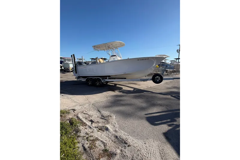 Slide: The Image of 2023 Sportsman Heritage 241 Center Console boat on trailer, sunny day. - 0