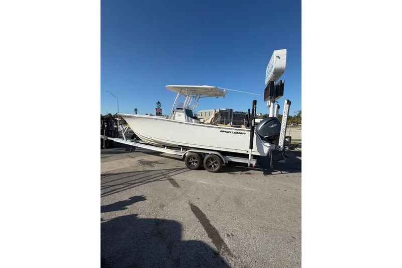 Slide: The Image of 2023 Sportsman Heritage 241 Center Console boat on trailer under clear blue sky. - 1