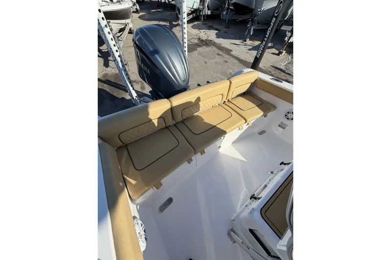 Slide: The Image of 2023 Sportsman Heritage 241 Center Console boat with tan seating and Yamaha engine. - 10