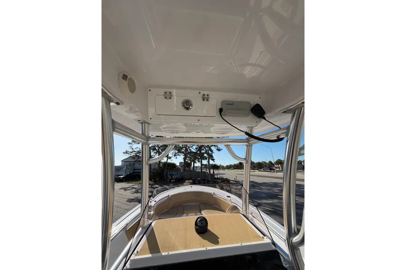 Slide: The Image of 2023 Sportsman Heritage 241 Center Console boat interior with console and seating view. - 11