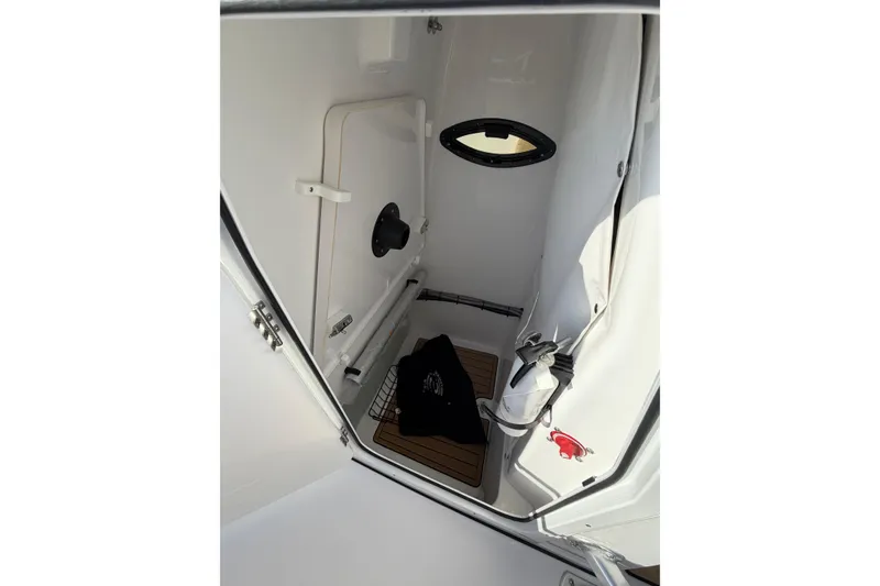 Slide: The Image of 2023 Sportsman Heritage 241 Center Console interior with storage compartment and wooden flooring. - 12
