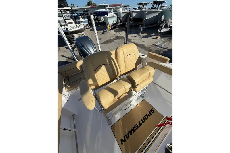 Slide: The Image of 2023 Sportsman Heritage 241 Center Console with tan seating, displayed among other boats. - 6