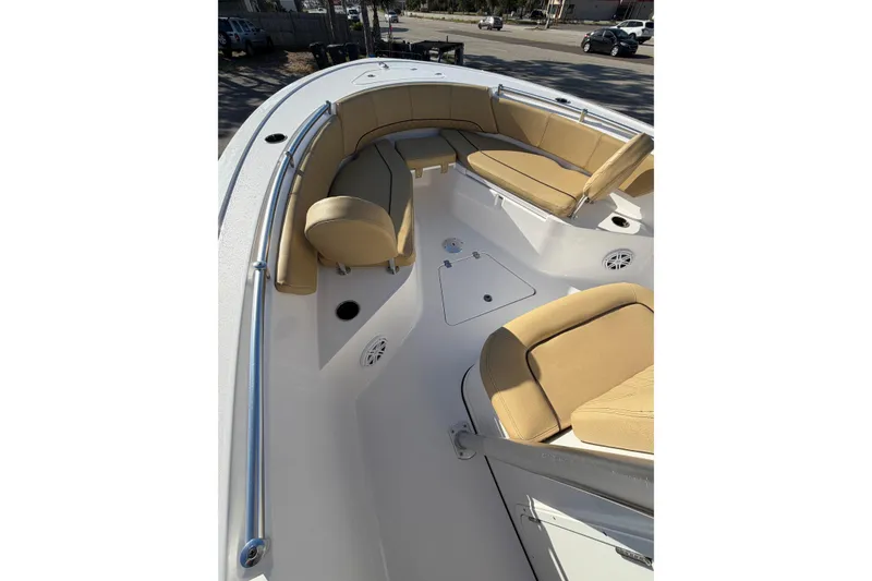 Slide: The Image of 2023 Sportsman Heritage 241 Center Console boat interior with tan seating and stainless steel railings. - 8