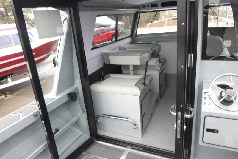 Slide: The Image of Interior of 2026 KingFisher 25 XAC boat with seating and steering wheel. - 19