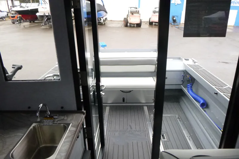 Slide: The Image of Interior view of 2026 KingFisher 25 XAC boat, featuring seating and a small sink. - 20