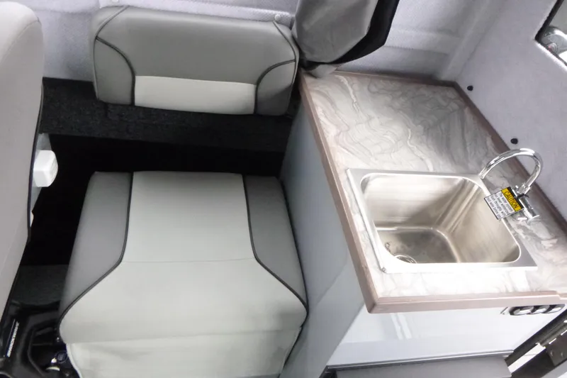 Slide: The Image of Interior of 2026 KingFisher 25 XAC boat with seating and compact sink. - 22