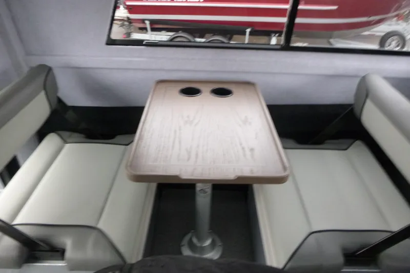Slide: The Image of Interior seating area of 2026 KingFisher 25 XAC boat with table and cup holders. - 24