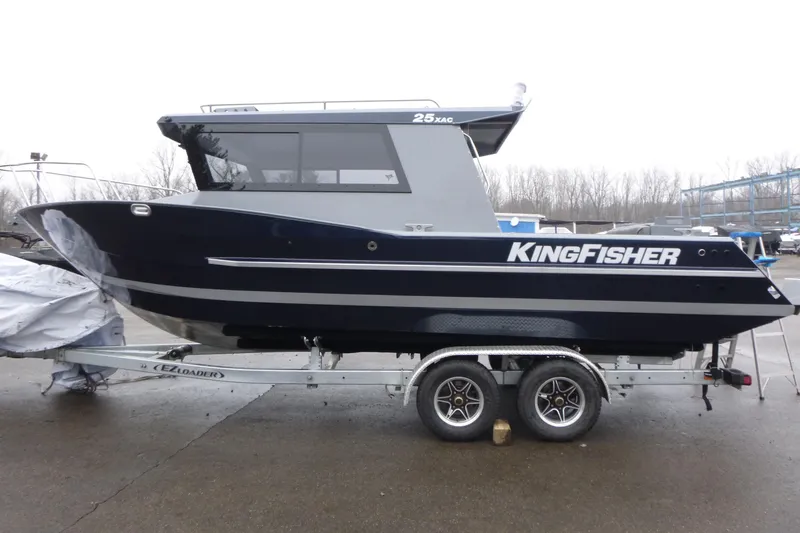 Slide: The Image of 2026 KingFisher 25 XAC boat on trailer, parked outdoors on a cloudy day. - 7