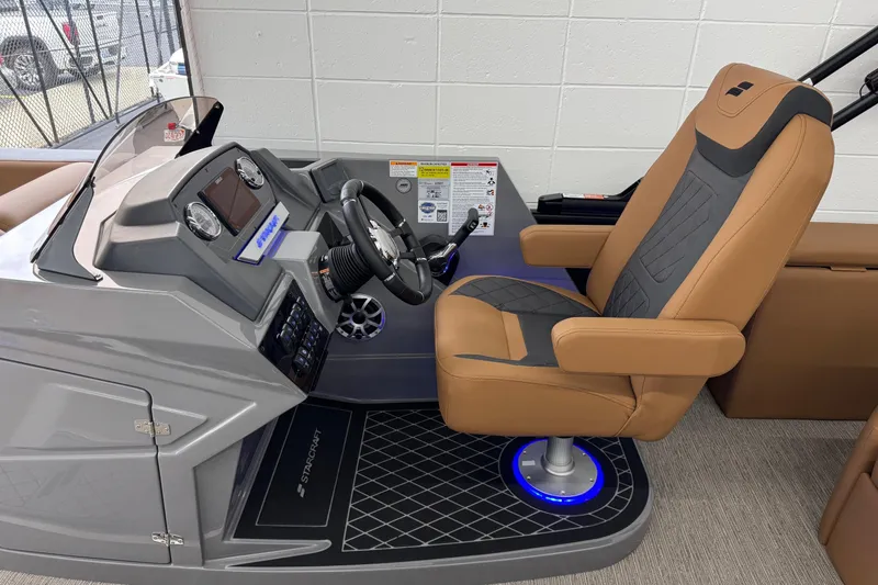 Slide: The Image of Captain's seat and helm of 2026 Starcraft SLS 3 Q DH boat, featuring modern controls. - 12