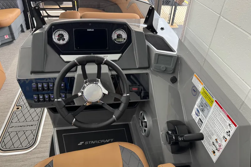 Slide: The Image of 2026 Starcraft SLS 3 Q DH boat dashboard with steering wheel and control panel. - 13