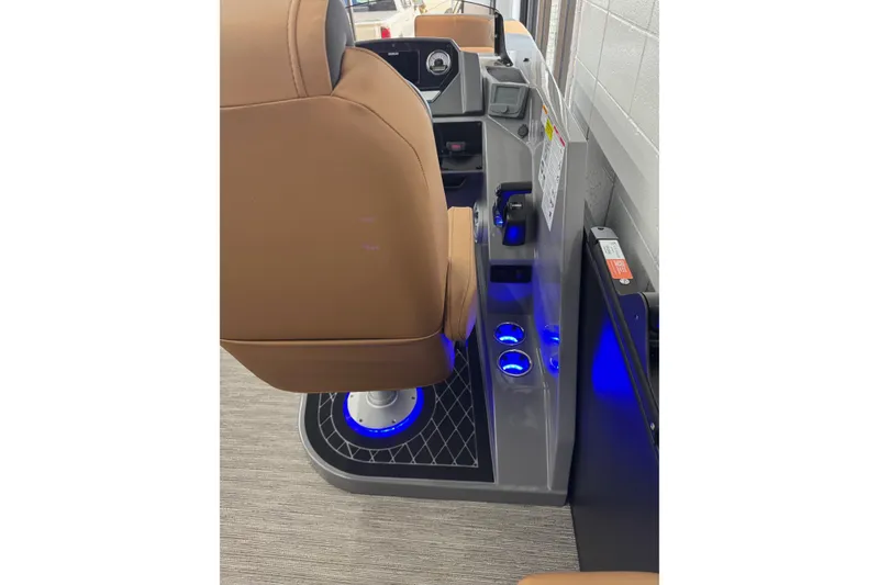 Slide: The Image of 2026 Starcraft SLS 3 Q DH boat interior with brown seating and illuminated controls. - 15