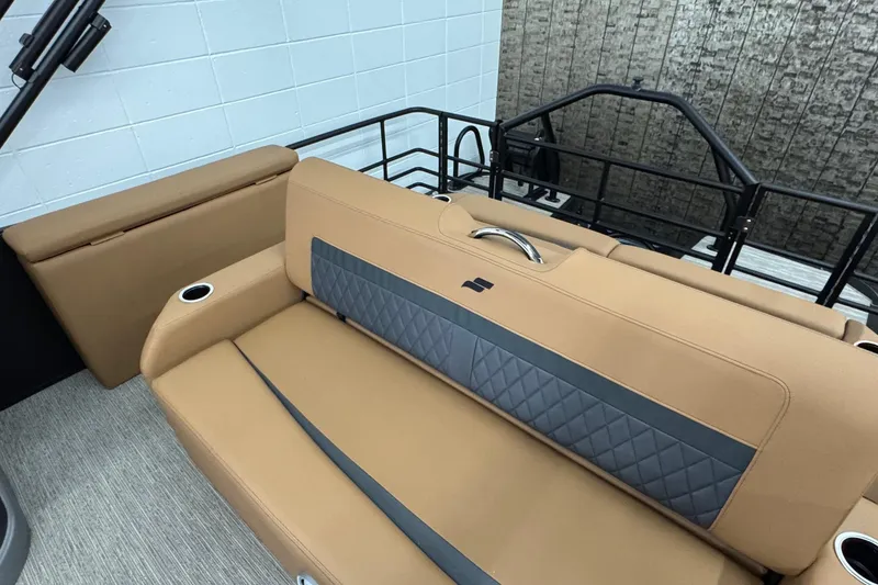 Slide: The Image of Luxurious seating in 2026 Starcraft SLS 3 Q DH boat, featuring tan upholstery and cup holders. - 19