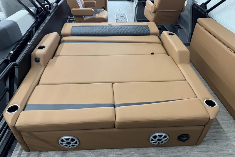 Slide: The Image of 2026 Starcraft SLS 3 Q DH boat interior with tan convertible seating and cup holders. - 22