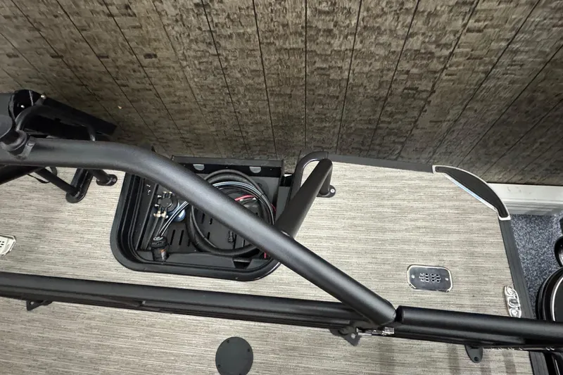 Slide: The Image of Interior view of 2026 Starcraft SLS 3 Q DH boat, featuring storage compartment and railing. - 32