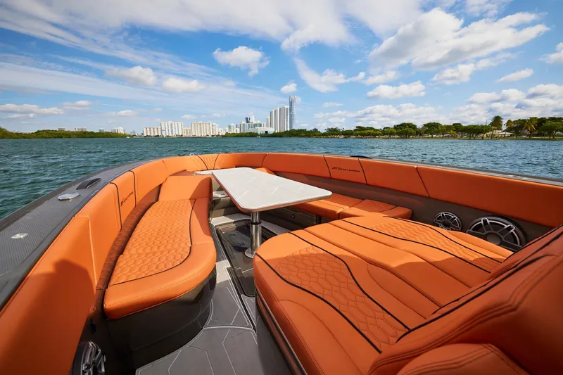 Slide: The Image of Luxurious Midnight Express 37' Open boat with orange seating, city skyline in background. - 10