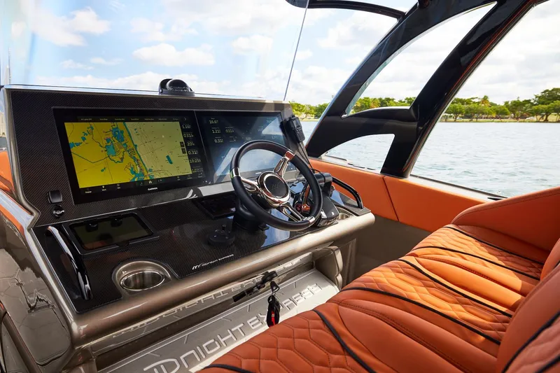 Slide: The Image of Cockpit of Midnight Express 37' Open boat with navigation display and luxurious seating. - 12