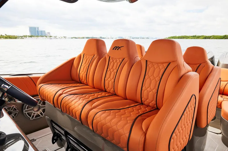 Slide: The Image of Luxurious orange seating on a Midnight Express 37' Open boat, with scenic water view. - 13