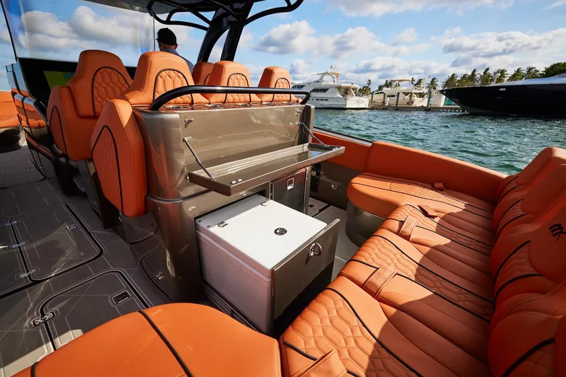 Slide: The Image of Luxurious interior of Midnight Express 37' Open boat with orange seating and scenic marina view. - 14