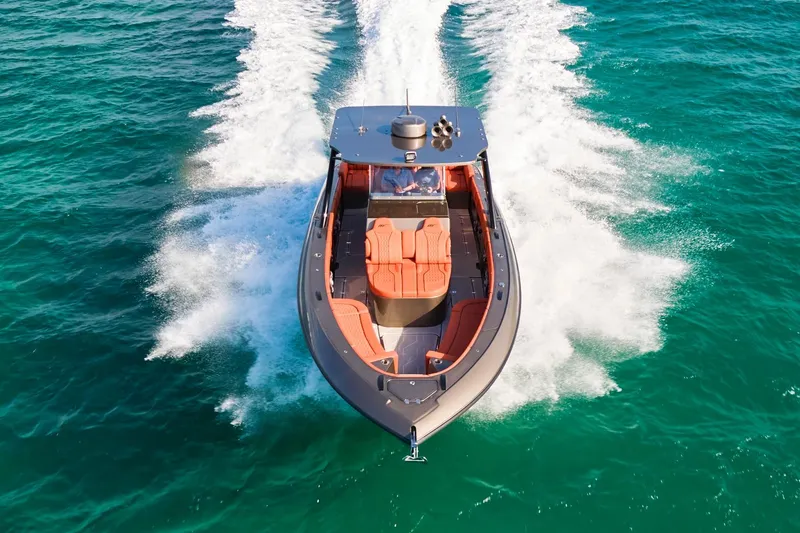Slide: The Image of Midnight Express 37' Open boat cruising on clear turquoise water, top view. - 2